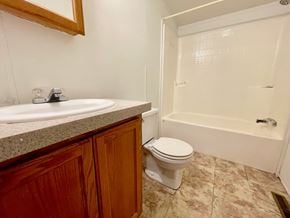 Charlestown house for rent - A bathroom with a toilet, sink, and bathtub.
