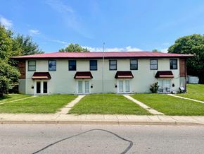 New Albany apartment for rent - A two-story house with a red roof and white siding.