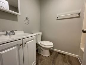 New Albany apartment for rent - A white toilet sits next to a sink in a small bathroom.