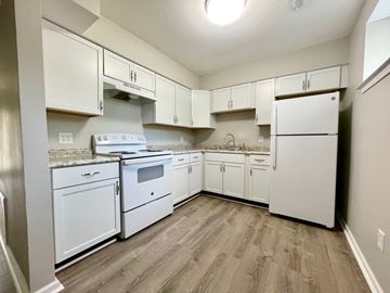 New Albany apartment for rent - A kitchen with white appliances and cabinets.