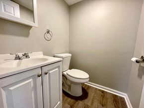 New Albany apartment for rent - A white toilet sits in a bathroom next to a sink.