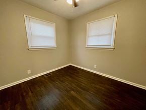 Louisville house for rent - an empty room with wood floors and two windows