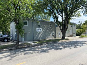 Grand Forks apartment for rent - a gray building with trees in front of it