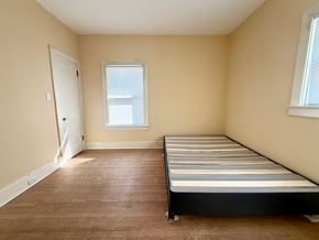 Louisville apartment for rent - A bedroom with a bed, window, and door.
