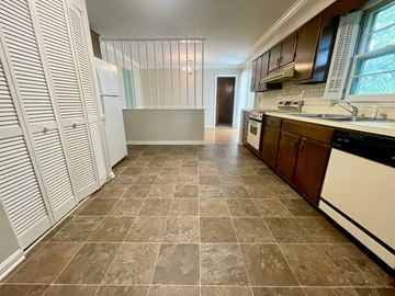 Louisville house for rent - A kitchen with brown tiled floors and white cabinets.
