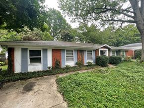 Louisville house for rent - A red and white house with a green lawn in front.