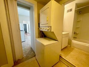 Louisville apartment for rent - a laundry room with a washer and dryer and a bathroom with a sink
