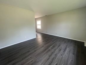 Louisville house for rent - A room with wooden flooring and a window.