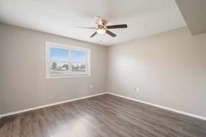 Clarksville apartment for rent - an empty bedroom with a ceiling fan and a window
