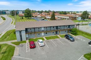 Clarksville apartment for rent - an aerial view of an apartment building in a parking lot with parked cars