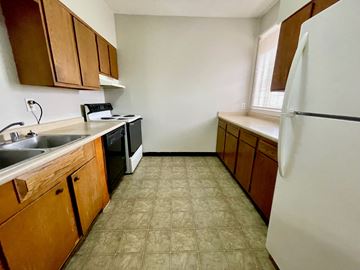 Louisville apartment for rent - an empty kitchen with a refrigerator and a sink