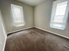 Louisville apartment for rent - an empty bedroom with two windows and a carpeted floor