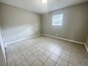 Louisville apartment for rent - an empty living room with tiled floors and a window