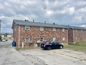 Louisville apartment for rent - a car parked in front of a brick apartment building