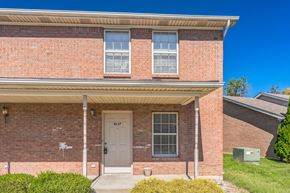 New Albany apartment for rent - the front of a brick building with a white door