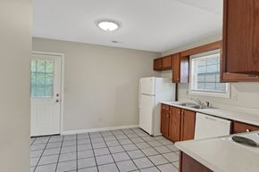 New Albany apartment for rent - an empty kitchen with white appliances and wooden cabinets
