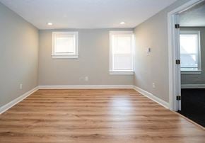 Akron apartment for rent - A room with wooden flooring and two windows.