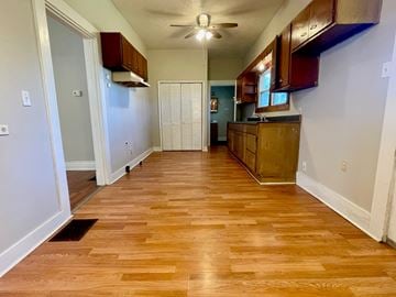 Louisville house for rent - A kitchen with wooden floors and white walls.