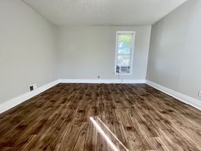 Louisville house for rent - A room with wooden flooring and a window.
