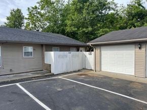 New Albany apartment for rent - a garage and a white fence in front of a house