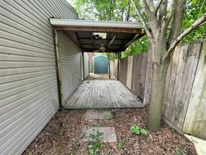 New Albany apartment for rent - a covered walkway with a tree and a blue door