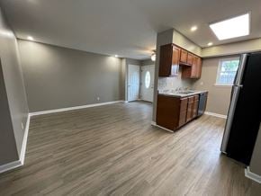 New Albany apartment for rent - an empty living room and kitchen with wood flooring