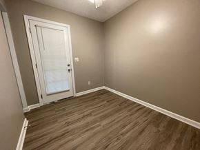 New Albany apartment for rent - a bedroom with wood flooring and a white door