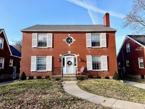 Louisville apartment for rent - A red brick house with a white door and windows.