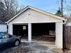 Louisville apartment for rent - A garage with a car parked in front of it.