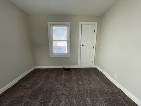 Louisville house for rent - an empty room with carpet and a window