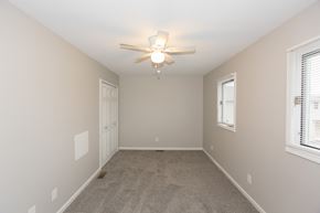 New Albany apartment for rent - an empty bedroom with a ceiling fan and a door