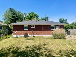 Louisville house for rent - the front of a brick house with a yard and grass