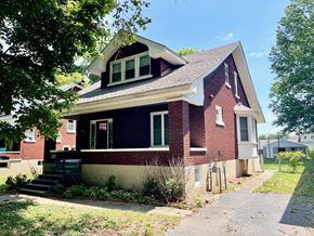 Louisville house for rent - a red brick house with a sidewalk in front of it