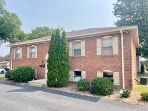 New Albany apartment for rent - A red brick house with a tree in front.