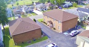 New Albany apartment for rent - A bird's eye view of a residential area with houses and cars.