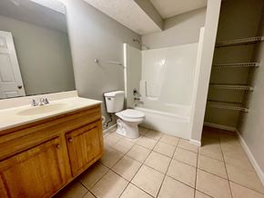 New Albany apartment for rent - A bathroom with a toilet, sink, and shower.