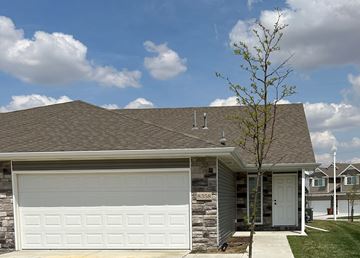 Lincoln house for rent - A house with a garage door and a tree in front.