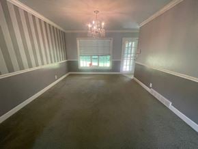 Louisville house for rent - a empty dining room with a chandelier