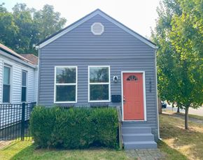Louisville house for rent - A small house with a red door and a grey exterior.