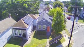 Louisville house for rent - A house with a red door is surrounded by a green lawn.
