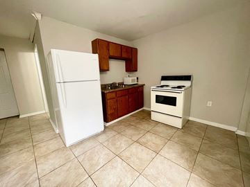 Louisville apartment for rent - a kitchen with a refrigerator and a stove and a sink