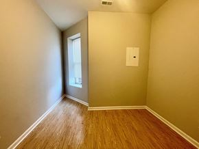 Louisville apartment for rent - the bedroom of a home with wood flooring and a window