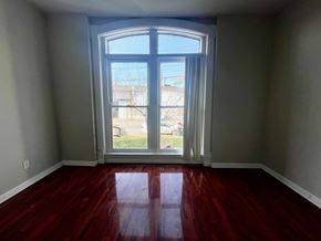 Louisville apartment for rent - a living room with a large window and wooden floors