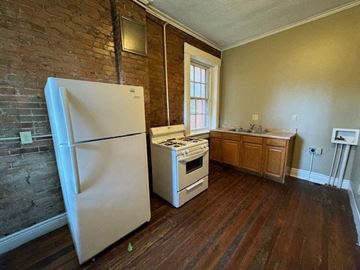 Louisville apartment for rent - an empty kitchen with a white refrigerator and a stove