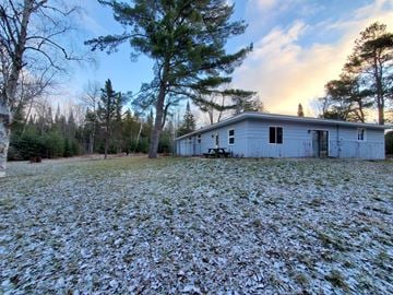 Petoskey house for rent - a white house with a yard covered in snow