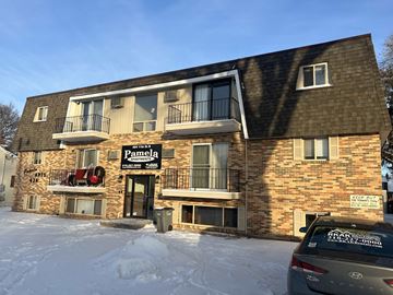 Moorhead apartment for rent - a building with a parking meter in the snow