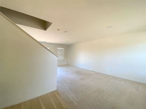 Merced house for rent - the living room and dining area of a house with white walls and flooring