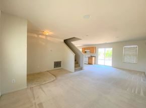 Merced house for rent - the living room and dining room are empty of furniture