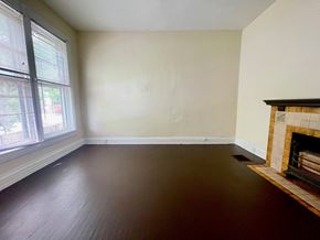 Louisville house for rent - A room with a fireplace and a window.