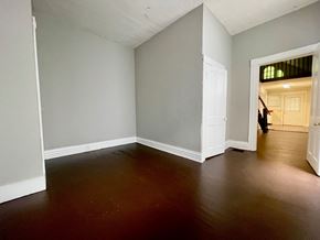 Louisville house for rent - A room with a wooden floor and white walls.